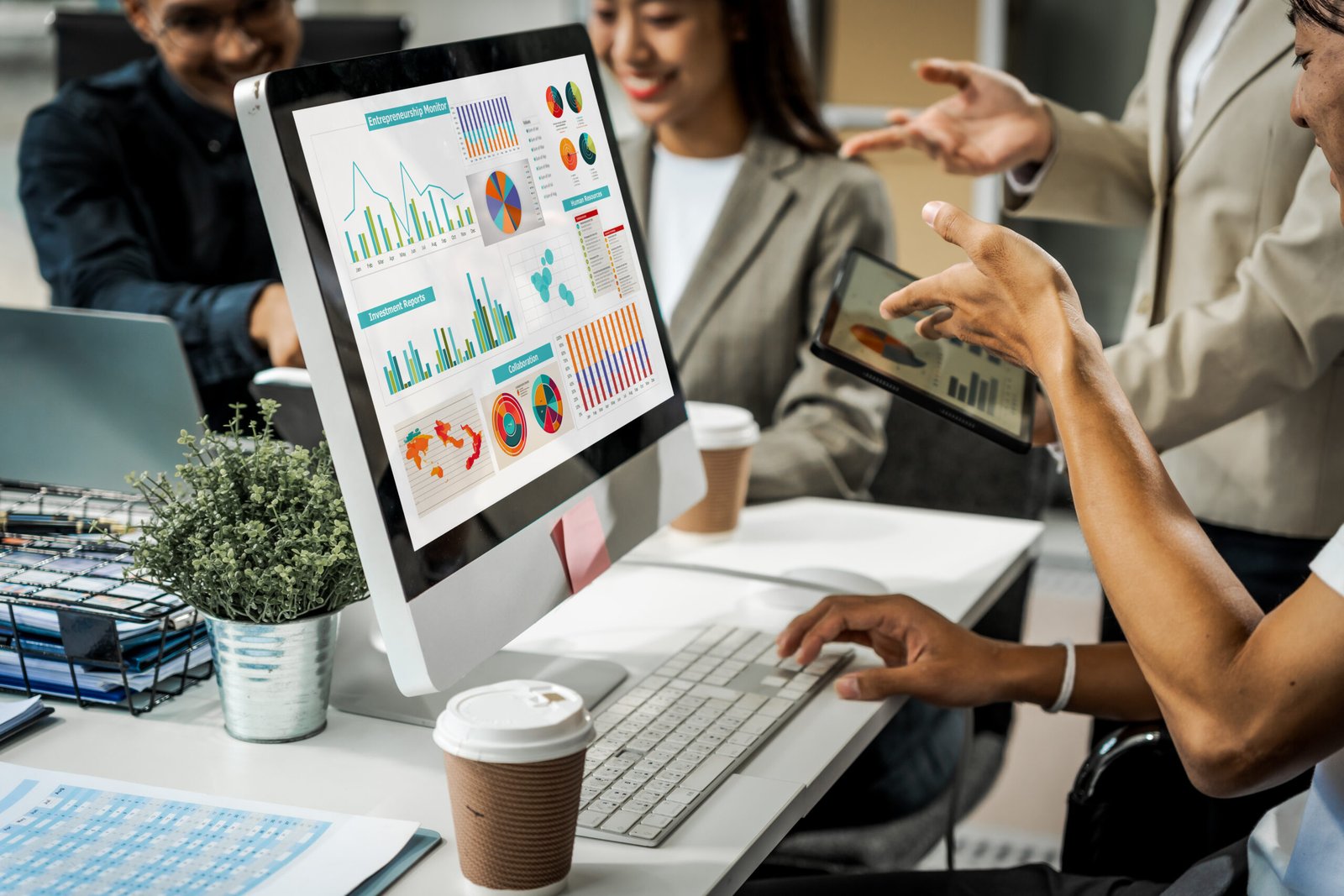 Asian colleagues meet at a desk, discussing business financial t
